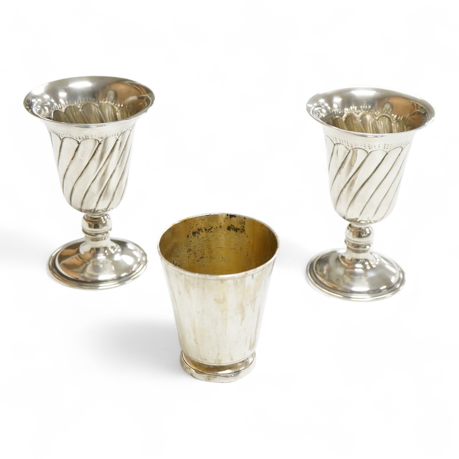 A pair of Turkish? 900 standard white metal goblets, 11.1cm, together with an 800 standard small beaker, 7oz.